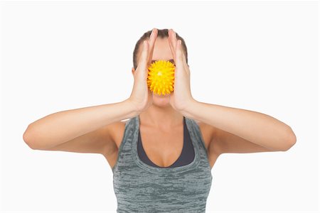 simsearch:400-07138263,k - Young woman holding massage ball between hands in front of her face on white screen Stock Photo - Budget Royalty-Free & Subscription, Code: 400-07138201