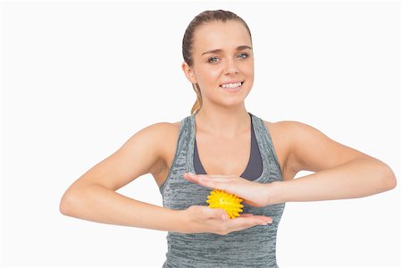 simsearch:400-07138263,k - Happy woman holding yellow massage ball between her hands smiling at camera Stock Photo - Budget Royalty-Free & Subscription, Code: 400-07138203