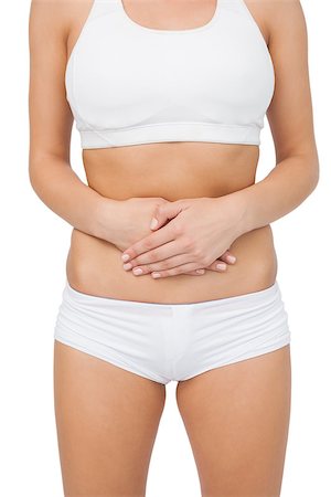 simsearch:400-07138263,k - Mid section of young woman touching her belly with her hands on white screen Stock Photo - Budget Royalty-Free & Subscription, Code: 400-07138237
