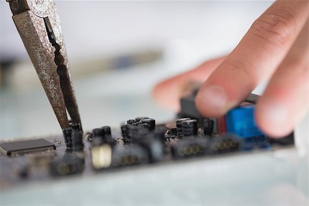 extreme sports and connect - Extreme close up of pliers repairing hardware held by hand in bright office Stock Photo - Budget Royalty-Free & Subscription, Code: 400-07138323