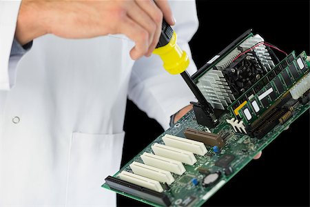 extreme sports and connect - Extreme close up of computer engineer repairing hardware at night on black background Stock Photo - Budget Royalty-Free & Subscription, Code: 400-07138352