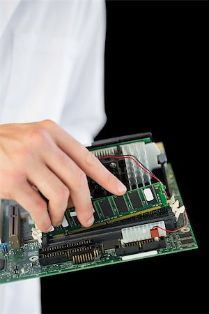 extreme sports and connect - Extreme close up of computer engineer holding hardware at night on black background Stock Photo - Budget Royalty-Free & Subscription, Code: 400-07138353