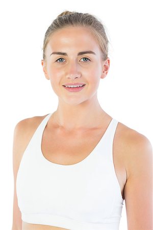 Attractive smiling blonde wearing sports bra looking at camera on white background Stock Photo - Budget Royalty-Free & Subscription, Code: 400-07138825