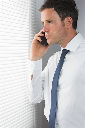 simsearch:400-07139155,k - Serious handsome businessman phoning in room Stock Photo - Budget Royalty-Free & Subscription, Code: 400-07139154