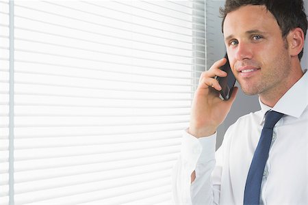 simsearch:400-07139155,k - Cheerful handsome businessman phoning in room Stock Photo - Budget Royalty-Free & Subscription, Code: 400-07139156