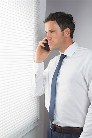 simsearch:400-07141016,k - Stern handsome businessman phoning in room Stockbilder - Microstock & Abonnement, Bildnummer: 400-07139153