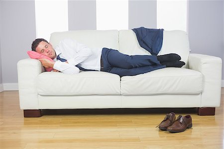 Calm attractive businessman lying on couch after work at home Stock Photo - Budget Royalty-Free & Subscription, Code: 400-07139170