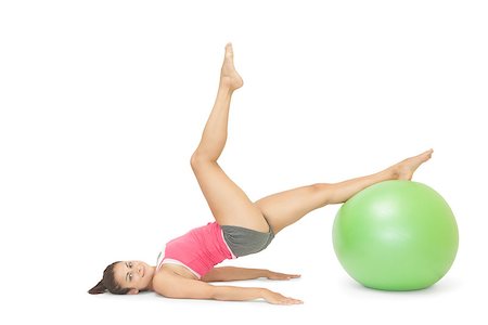 simsearch:400-07139290,k - Smiling sporty brunette exercising with exercise ball on white background Stock Photo - Budget Royalty-Free & Subscription, Code: 400-07139214