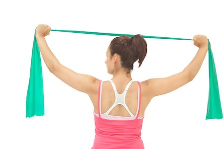 simsearch:400-07139290,k - Rear view of sporty brunette stretching with resistance band on white background Stock Photo - Budget Royalty-Free & Subscription, Code: 400-07139217