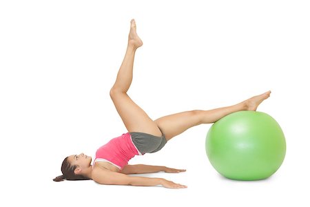 simsearch:400-07139290,k - Attractive sporty brunette exercising with exercise ball on white background Stock Photo - Budget Royalty-Free & Subscription, Code: 400-07139213