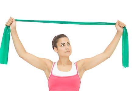 simsearch:400-07139290,k - Calm sporty brunette stretching with resistance band on white background Stock Photo - Budget Royalty-Free & Subscription, Code: 400-07139227