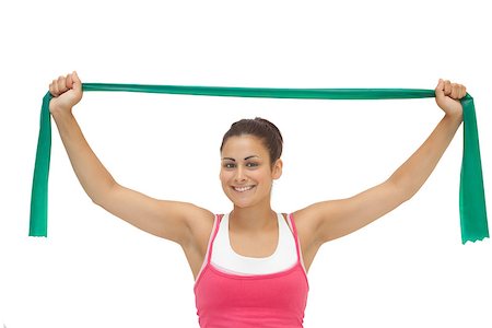 simsearch:400-07139290,k - Pretty sporty brunette stretching with resistance band on white background Stock Photo - Budget Royalty-Free & Subscription, Code: 400-07139228