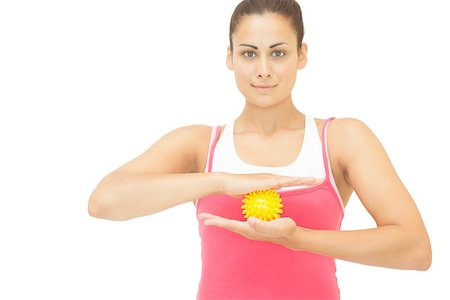 simsearch:400-07139290,k - Content sporty brunette holding yellow message ball on white background Stock Photo - Budget Royalty-Free & Subscription, Code: 400-07139236