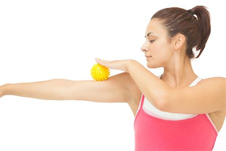 simsearch:400-07139290,k - Peaceful sporty brunette touching arm with yellow massage ball on white background Stock Photo - Budget Royalty-Free & Subscription, Code: 400-07139238