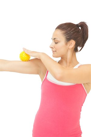 simsearch:400-07139290,k - Content sporty brunette touching arm with yellow massage ball on white background Stock Photo - Budget Royalty-Free & Subscription, Code: 400-07139239