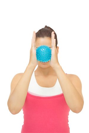 simsearch:400-07139290,k - Sporty brunette holding blue massage ball between hands on white background Stock Photo - Budget Royalty-Free & Subscription, Code: 400-07139246