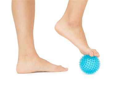 female foot massage - Close up of female feet touching blue massage ball on white background Photographie de stock - Aubaine LD & Abonnement, Code: 400-07139249