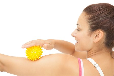 simsearch:400-07139290,k - Cheerful sporty brunette touching arm with yellow massage ball on white background Stock Photo - Budget Royalty-Free & Subscription, Code: 400-07139242