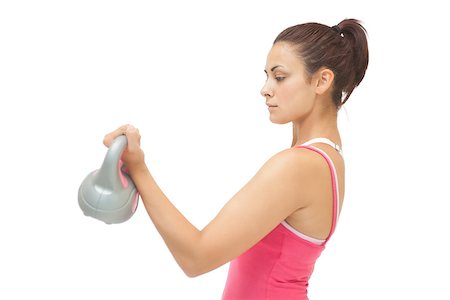 simsearch:400-07139290,k - Attractive sporty brunette holding grey and pink kettlebell on white background Stock Photo - Budget Royalty-Free & Subscription, Code: 400-07139256