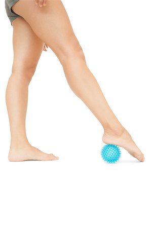 female foot massage - Close up of female legs touching blue massage ball on white background Photographie de stock - Aubaine LD & Abonnement, Code: 400-07139250