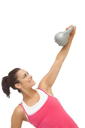 simsearch:400-07139290,k - Cheerful sporty brunette holding grey and kettlebell on white background Stock Photo - Budget Royalty-Free & Subscription, Code: 400-07139263