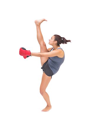 simsearch:400-07139290,k - Pretty sporty brunette kick boxing on white background Stock Photo - Budget Royalty-Free & Subscription, Code: 400-07139274