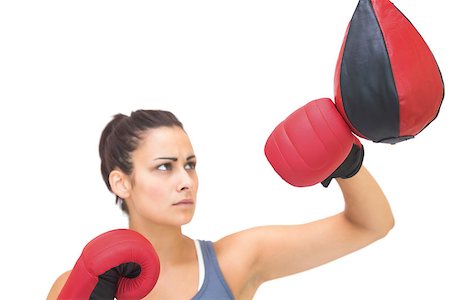 simsearch:400-07139290,k - Serious sporty brunette training with punching bag on white background Stock Photo - Budget Royalty-Free & Subscription, Code: 400-07139277