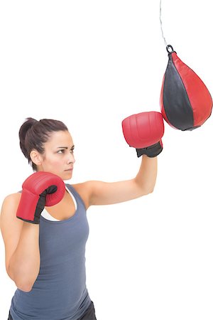 simsearch:400-07139290,k - Stern sporty brunette training with punching bag on white background Stock Photo - Budget Royalty-Free & Subscription, Code: 400-07139278