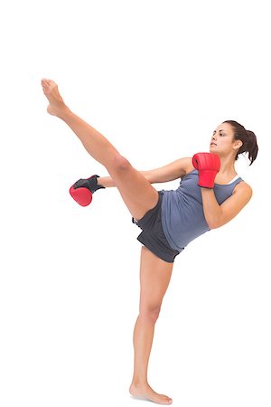 simsearch:400-07139290,k - Attractive sporty brunette kick boxing on white background Stock Photo - Budget Royalty-Free & Subscription, Code: 400-07139273