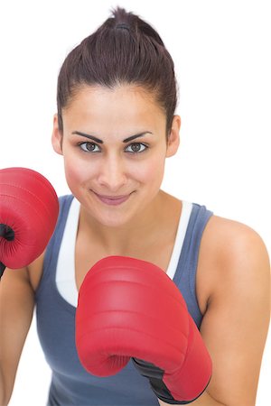 simsearch:400-07139290,k - Content sporty brunette wearing red boxing gloves on white background Stock Photo - Budget Royalty-Free & Subscription, Code: 400-07139284