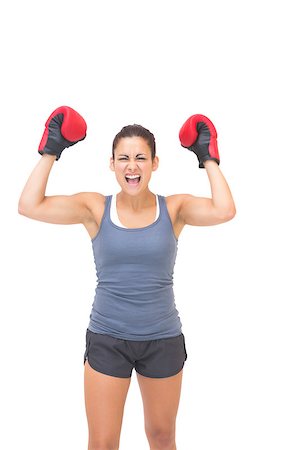 simsearch:400-07139290,k - Excited sporty brunette wearing red boxing gloves on white background Stock Photo - Budget Royalty-Free & Subscription, Code: 400-07139285