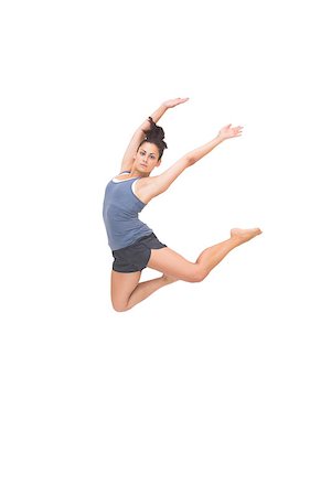 simsearch:400-07139290,k - Pretty sporty brunette jumping in the air with arms up on white background Stock Photo - Budget Royalty-Free & Subscription, Code: 400-07139287