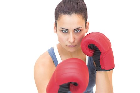 simsearch:400-07139290,k - Attractive sporty brunette wearing red boxing gloves on white background Stock Photo - Budget Royalty-Free & Subscription, Code: 400-07139282