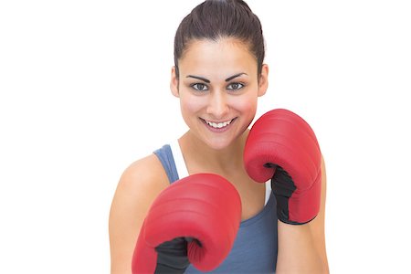 simsearch:400-07139290,k - Smiling sporty brunette wearing red boxing gloves on white background Stock Photo - Budget Royalty-Free & Subscription, Code: 400-07139283