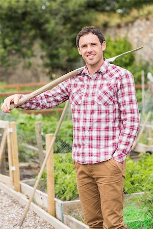 simsearch:400-07927044,k - Young brunette man posing with a shovel in his garden Stock Photo - Budget Royalty-Free & Subscription, Code: 400-07139562