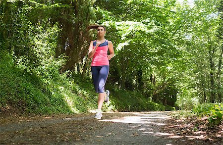 simsearch:400-07682342,k - Pretty young woman jogging in a forest on a sunny day Stock Photo - Budget Royalty-Free & Subscription, Code: 400-07139817