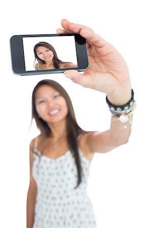 simsearch:400-06889355,k - Smiling asian woman taking a selfie using her smartphone Stockbilder - Microstock & Abonnement, Bildnummer: 400-07139910