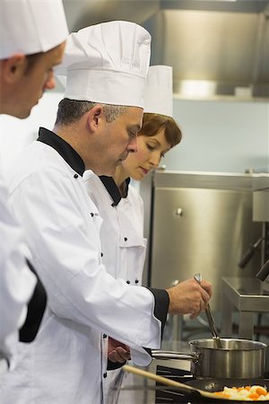 Head chef inspecting his students pot in a kitchen Stock Photo - Budget Royalty-Free & Subscription, Code: 400-07139935