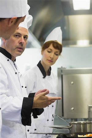 simsearch:400-07140055,k - Male mature chef explaining something to a colleague while standing in front of the cooker Stock Photo - Budget Royalty-Free & Subscription, Code: 400-07139937