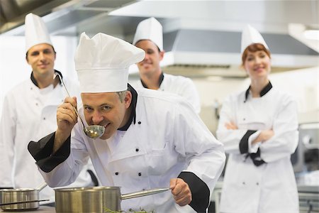 simsearch:400-07141137,k - Head chef tasting a soup and smiling at camera while being watched by his colleagues Stock Photo - Budget Royalty-Free & Subscription, Code: 400-07139941