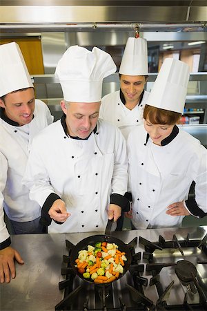 simsearch:400-07141137,k - Experienced head chef explaining something to his colleagues in the kitchen Stock Photo - Budget Royalty-Free & Subscription, Code: 400-07139943