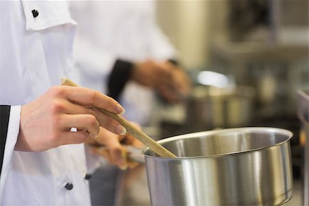 simsearch:400-07141137,k - Chefs working at a stove in a commercial kitchen Stock Photo - Budget Royalty-Free & Subscription, Code: 400-07139950