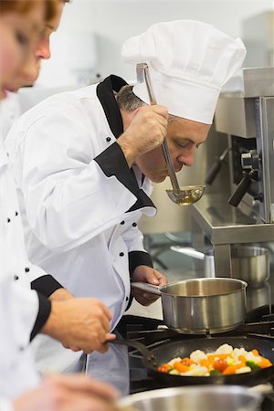 simsearch:400-07140055,k - Three chefs working at the stove in commercial kitchen Stock Photo - Budget Royalty-Free & Subscription, Code: 400-07139951