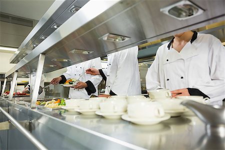 simsearch:400-07141137,k - Four chefs working in a kitchen at the order station Stock Photo - Budget Royalty-Free & Subscription, Code: 400-07139967
