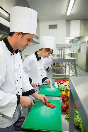 simsearch:400-07140008,k - Two young chefs cutting vegetables in industrial kitchen Photographie de stock - Aubaine LD & Abonnement, Code: 400-07139960