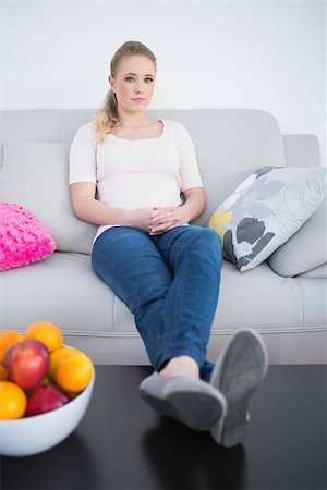 Casual content blonde sitting with feet on table in bright living room Stock Photo - Budget Royalty-Free & Subscription, Code: 400-07130667