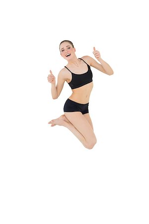 simsearch:400-07138263,k - Euphoric slim model jumping in the air on white background Stock Photo - Budget Royalty-Free & Subscription, Code: 400-07132527