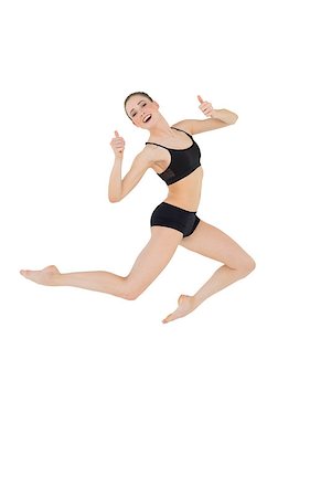 simsearch:400-07139290,k - Cheerful slim model jumping in the air on white background Stock Photo - Budget Royalty-Free & Subscription, Code: 400-07132528