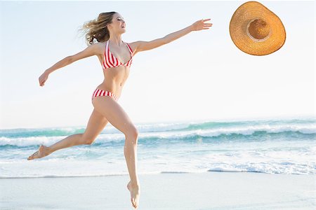 Elegant young woman jumping on beach trying to catch a straw hat Foto de stock - Super Valor sin royalties y Suscripción, Código: 400-07132660