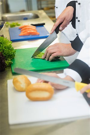 simsearch:400-07140055,k - Close up of chefs slicing bread rolls and asparagus in busy kitchen Stock Photo - Budget Royalty-Free & Subscription, Code: 400-07140012